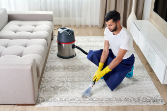 man-cleaning-carpet-living-room-using-vacuum-cleaner-home.jpg